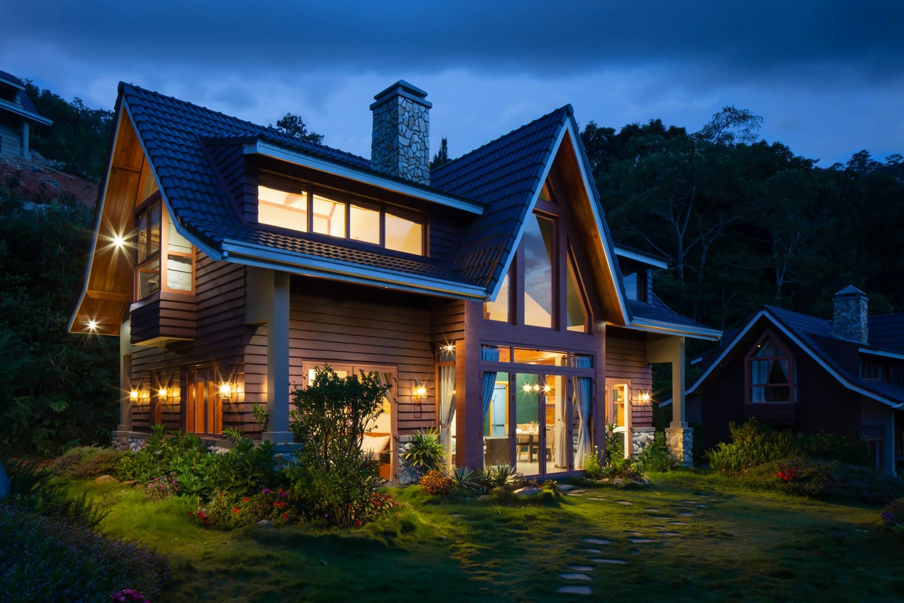A warmly lit family home at dusk
